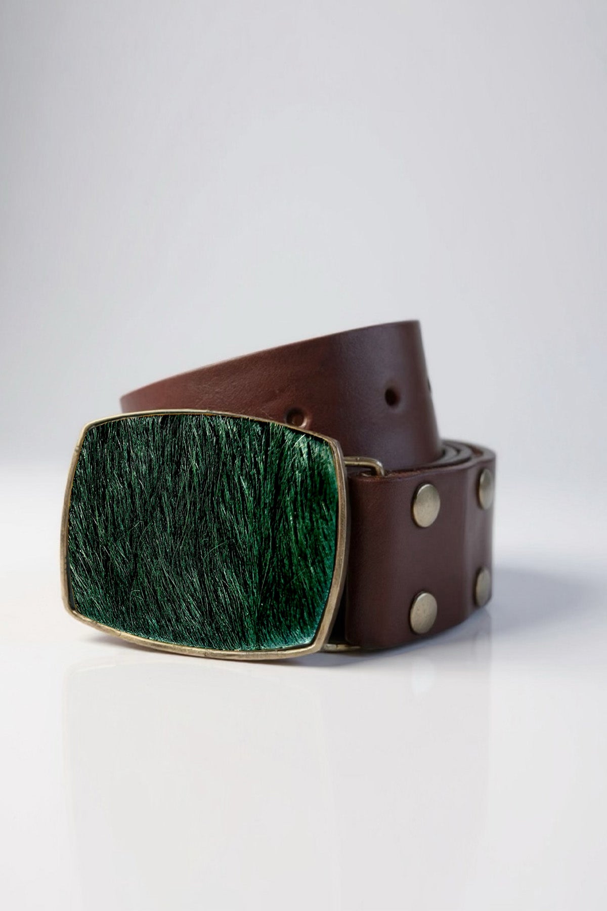 Brown leather belt with a green buckle on a white background