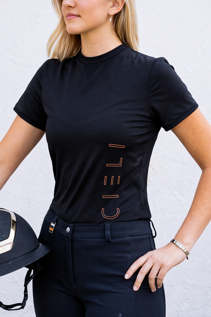 Person wearing a black t-shirt with 'CIELI' branding, holding a helmet against a light gray background