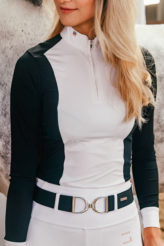 Blonde haired girl wearing long sleeve Cieli Equestrian show shirt in navy with UV protection