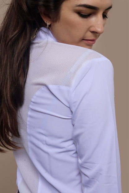 Woman wearing a white long-sleeve top with a mesh pattern on a beige background