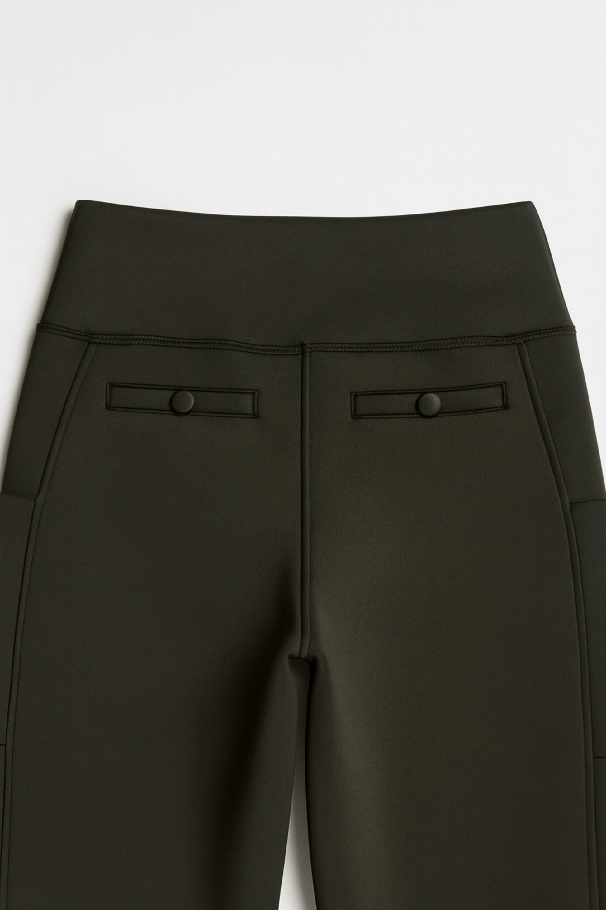 Black pants with button details on a white background