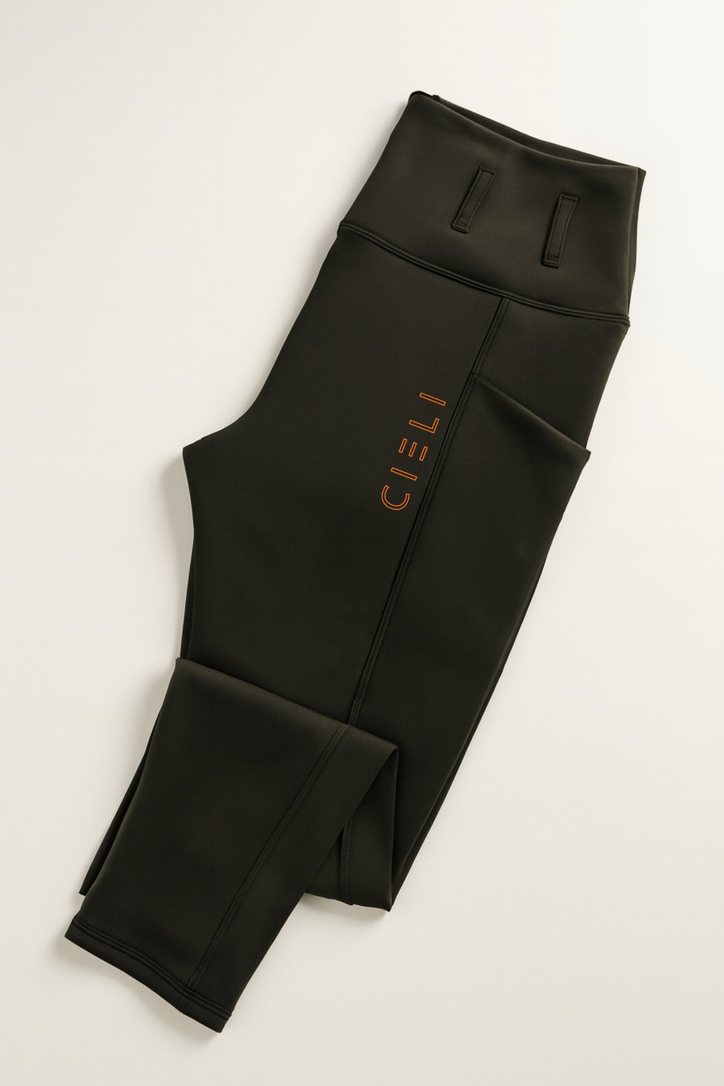 Black leggings with a brand logo on a light gray background