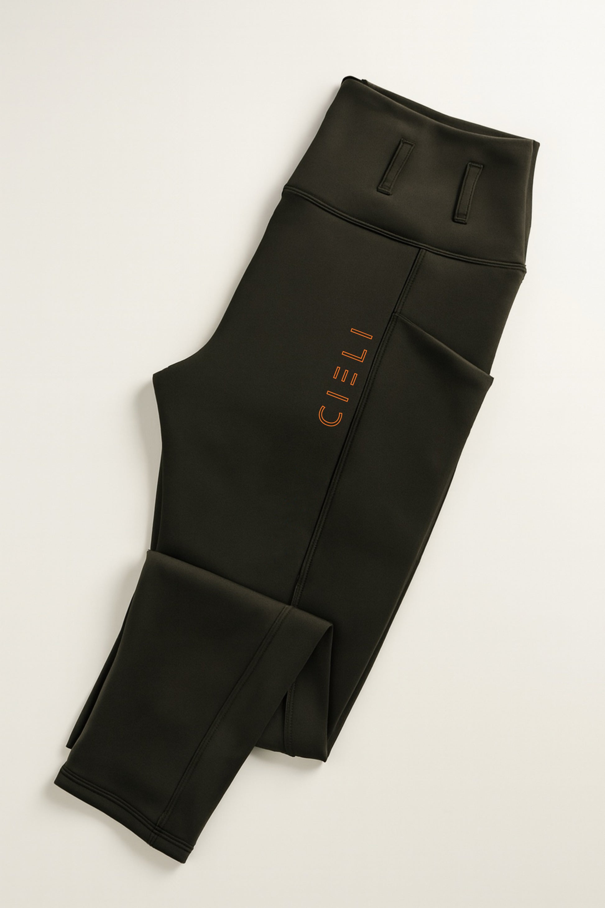 Black leggings with a brand logo on a light gray background