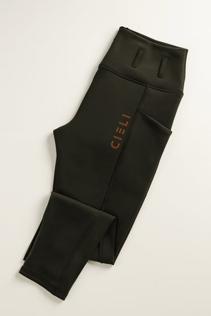 Black leggings with a brand logo on a light gray background