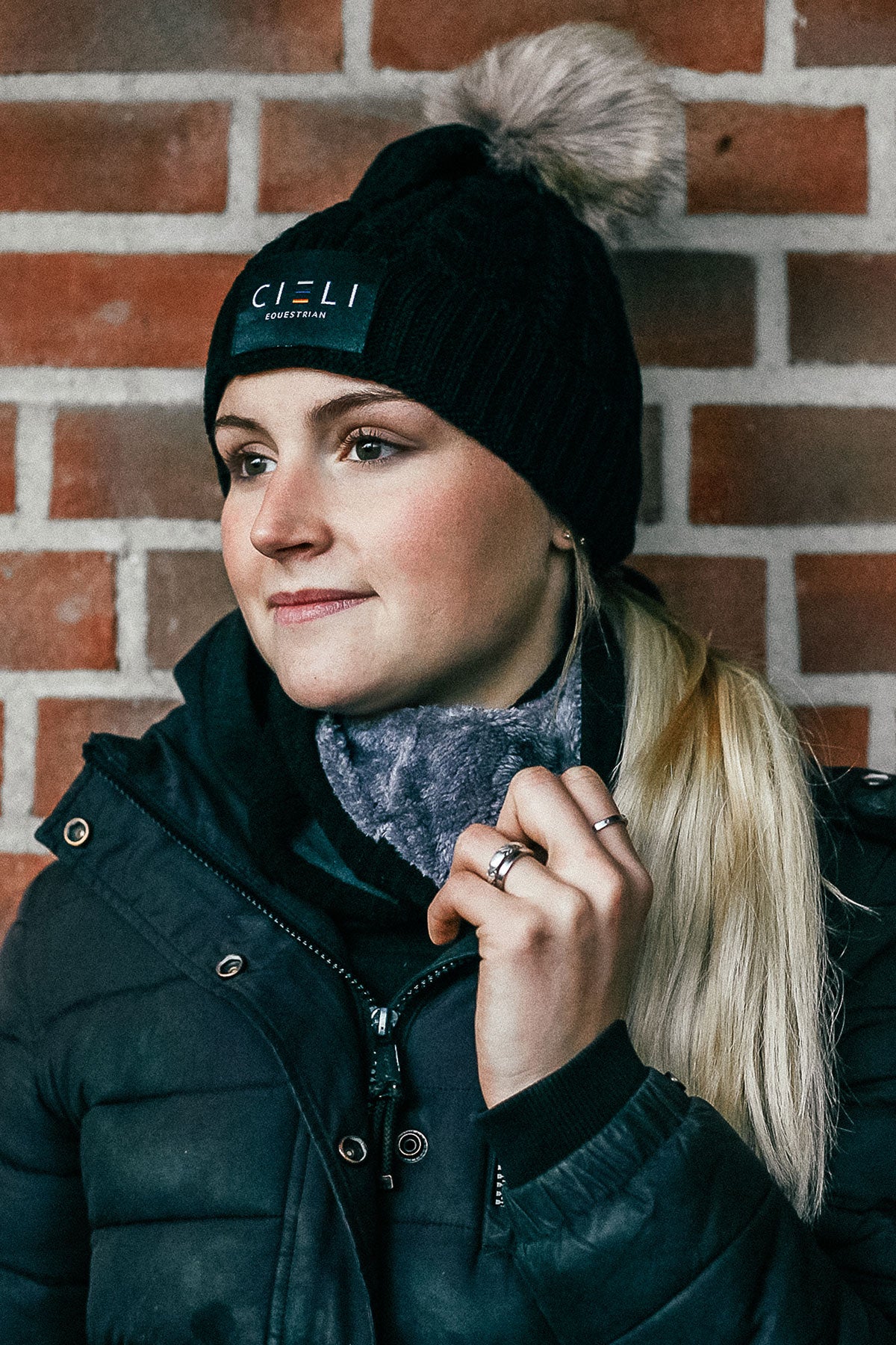 Lady wearing a Signature Cieli Equestrian snood scarf in black ideal for horse riding winters