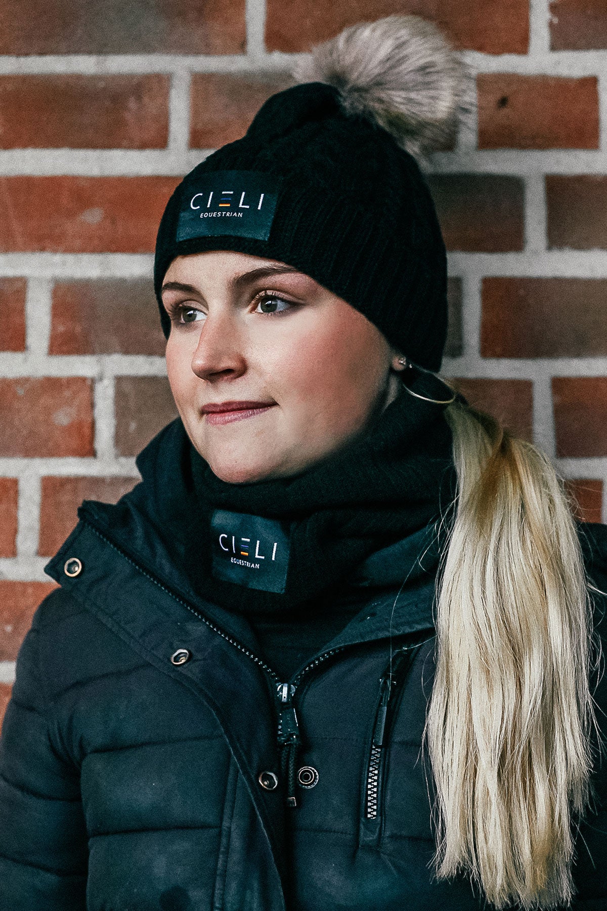 Lady wearing a Signature Cieli Equestrian snood scarf in black ideal for horse riding winters