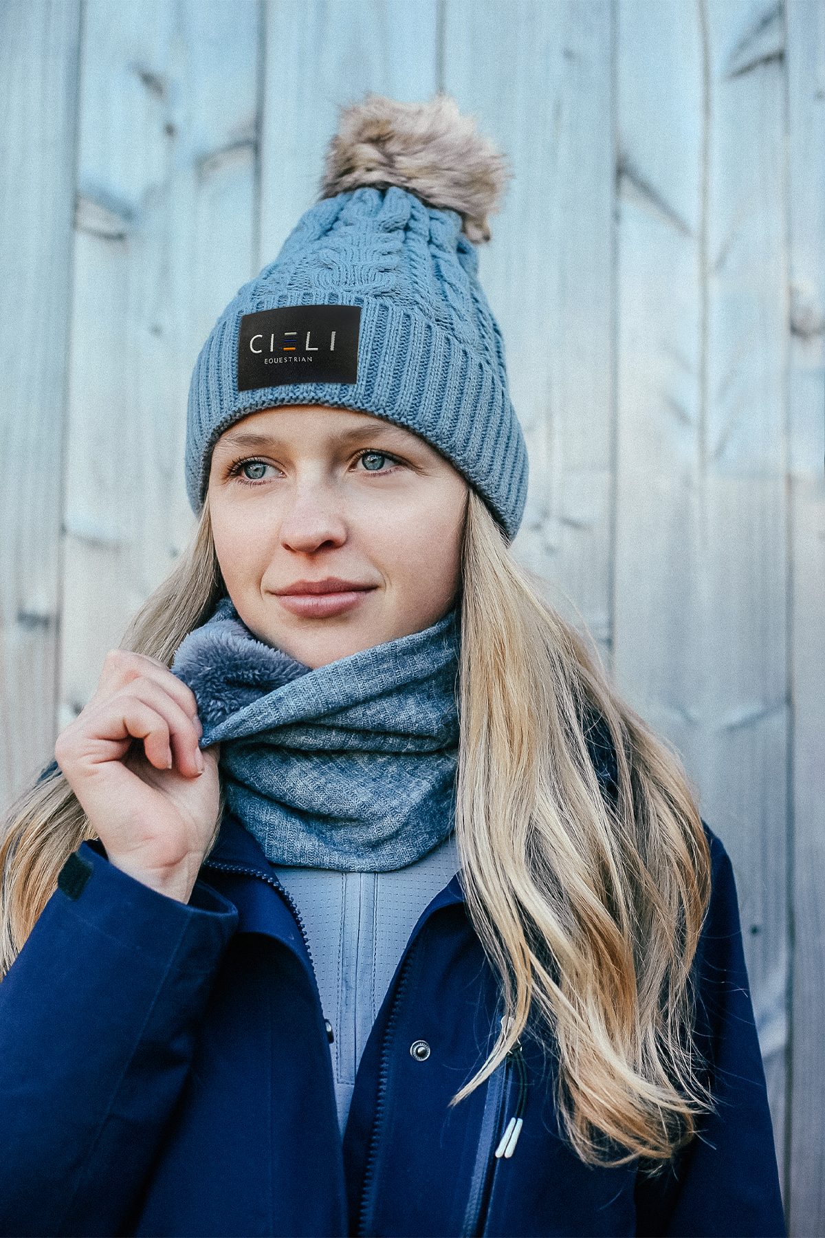 Lady wearing a Signature Cieli Equestrian snood scarf in grey ideal for horse riding winters