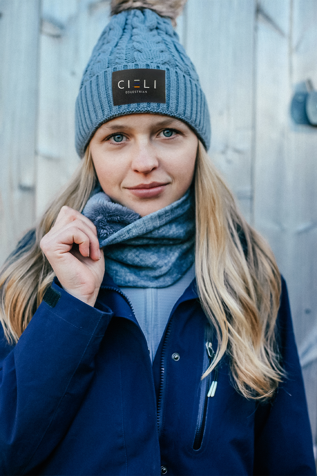 Lady wearing a Signature Cieli Equestrian snood scarf in grey ideal for horse riding winters