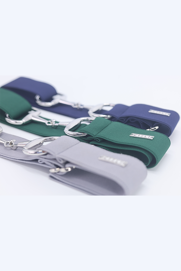 Three elastic belts in blue, green, and gray on a white background