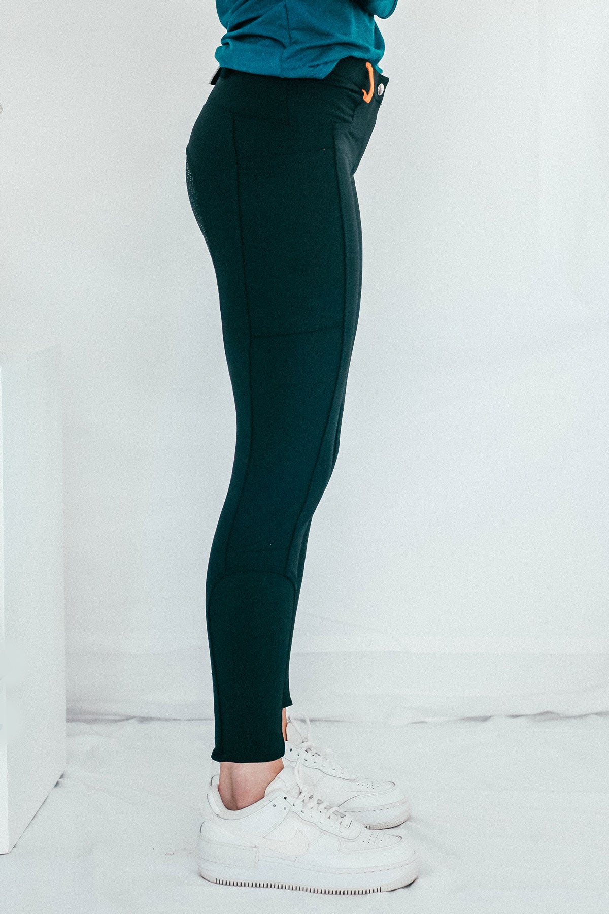 Lady wearing everyday black equestrian pants, resembling a sporty twist on modern riding breeches.