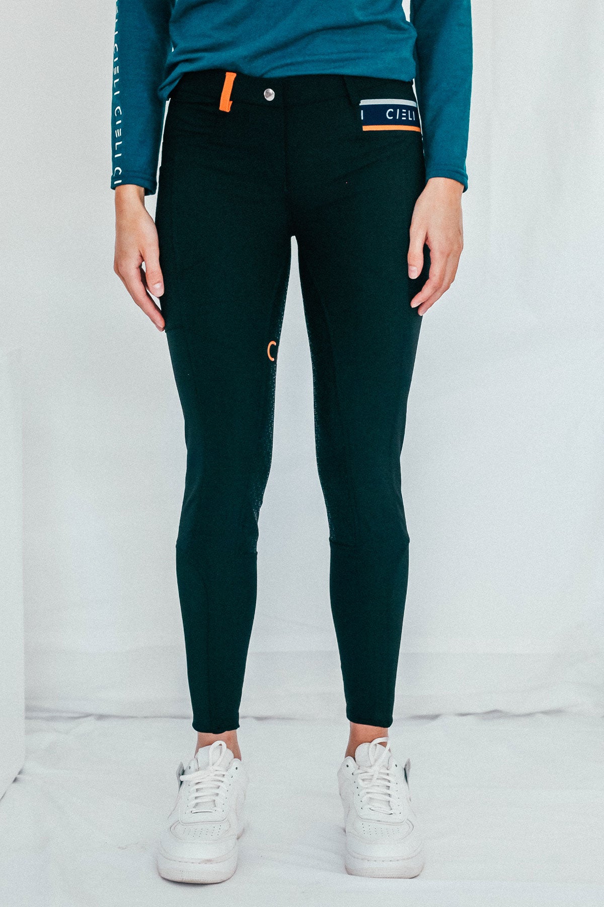 Lady wearing everyday black equestrian pants, resembling a sporty twist on modern riding breeches.