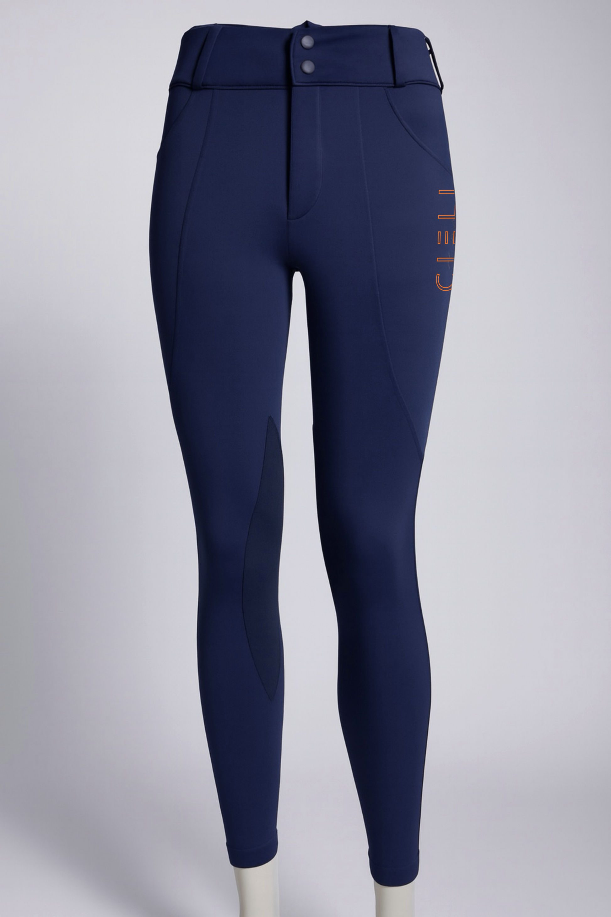 Navy blue riding pants with a visible brand logo on a light gray background