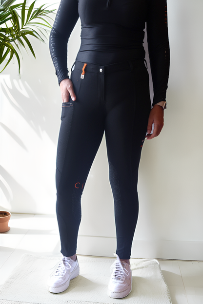 Lady wearing Cieli Equestrian everyday Chicago black equestrian pants, resembling a sporty twist on modern riding breeches also ideal for horse safari..