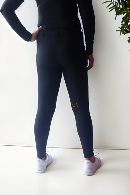 Lady wearing Cieli Equestrian everyday Chicago black equestrian pants, resembling a sporty twist on modern riding breeches also ideal for horse safari..