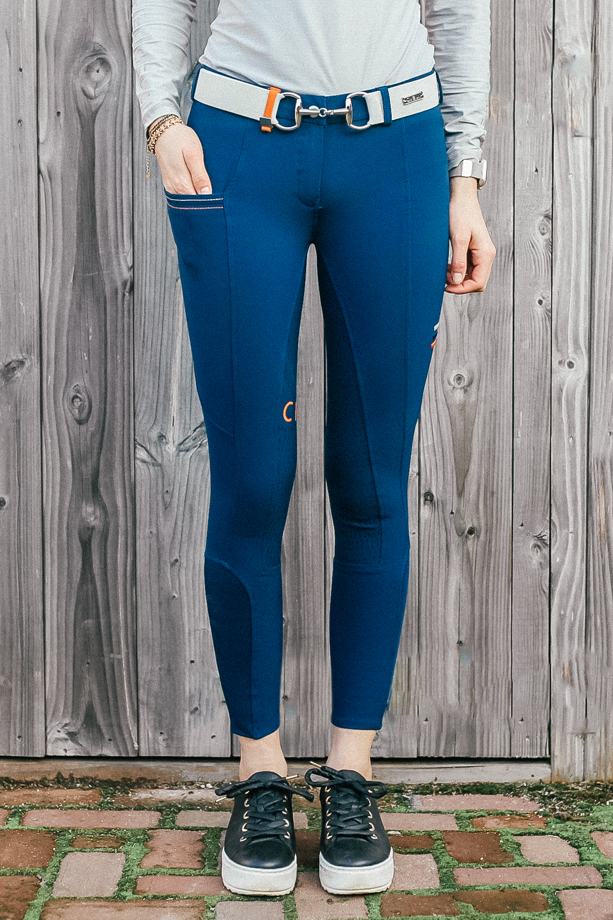 Lady wearing Cieli Equestrian everyday Chicago blue equestrian pants, resembling a sporty twist on modern riding breeches also ideal for horse safari..