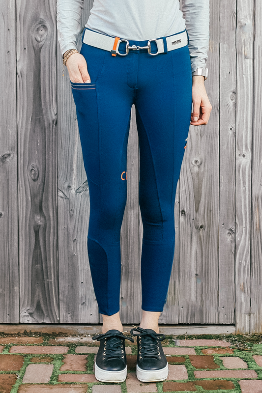 Lady wearing Cieli Equestrian everyday Chicago blue equestrian pants, resembling a sporty twist on modern riding breeches also ideal for horse safari..