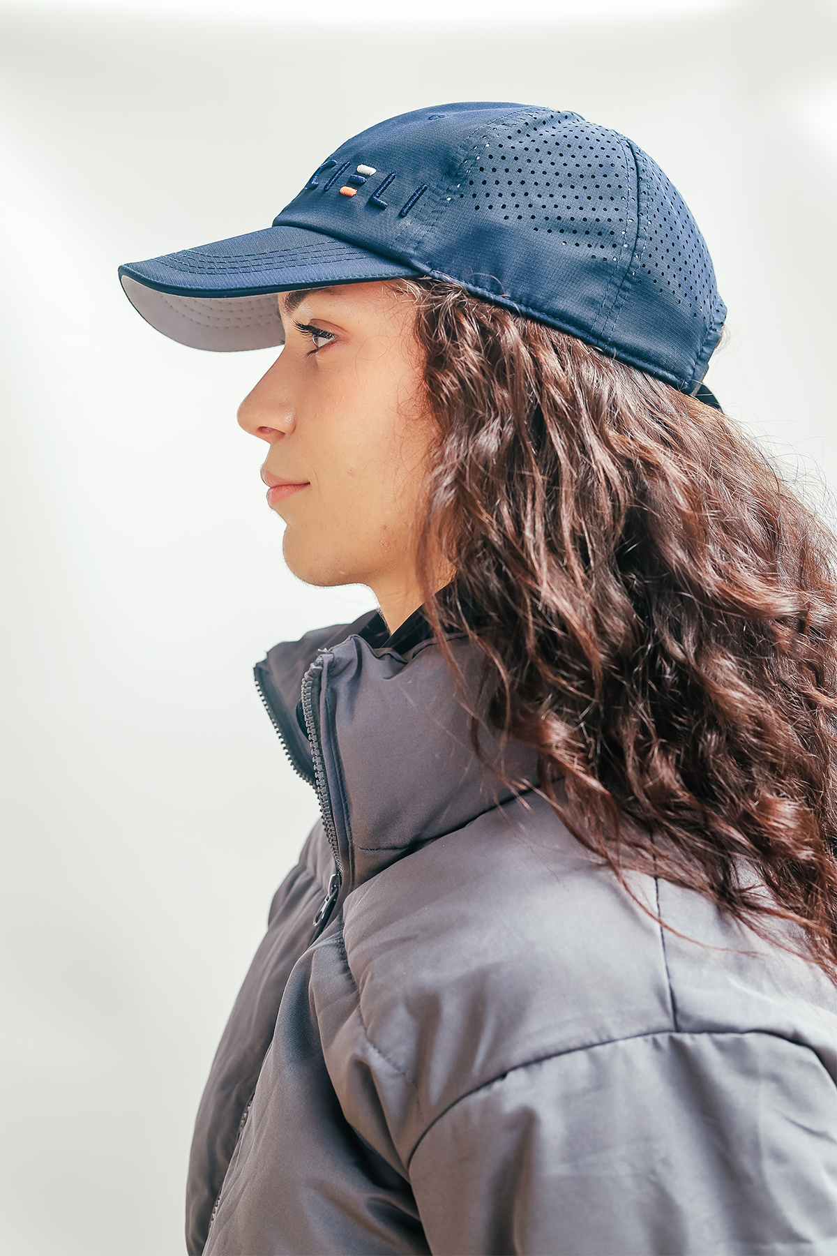 A Cieli Equestrian peak mesh baseball cap in navy blue ideal for horse safari.