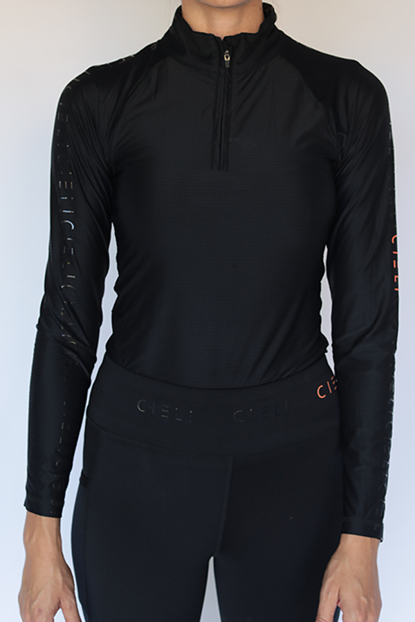 Lady wearing a Cieli Equestrian black riding shirt perfect for equestrians and ideal for horse safaris with sun protective fabric.