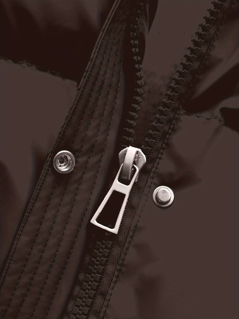 Close-up of a zipper on a dark jacket with a blurred background