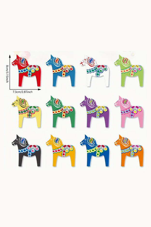 Colorful Dala horse figurines of various sizes on a white background