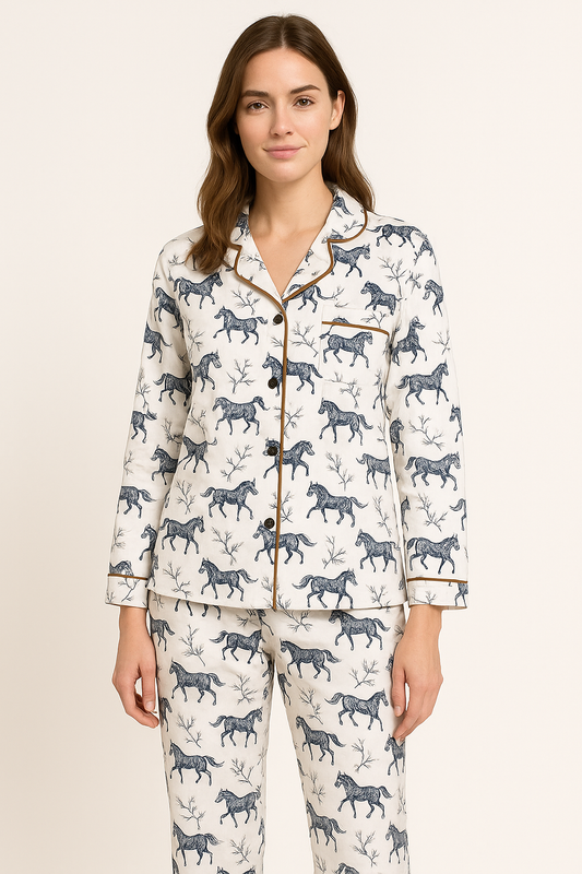 Lady wearing winter pyjamas with a black horse and flower print with brown piping on a white background