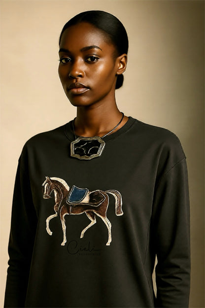 Woman wearing a Green sweatshirt with a horse design on a beige background