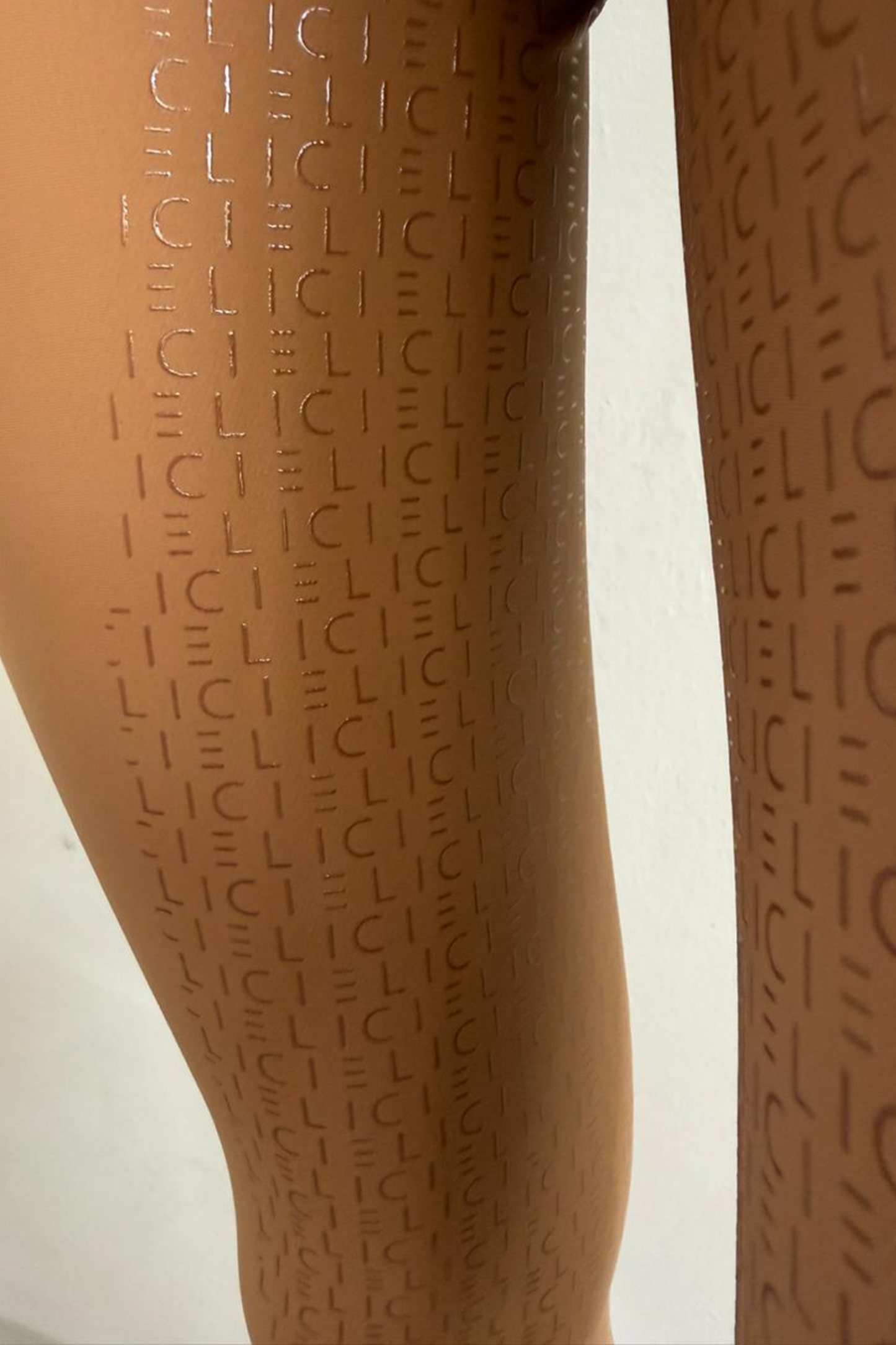 Brown breeches with a subtle pattern on a white background