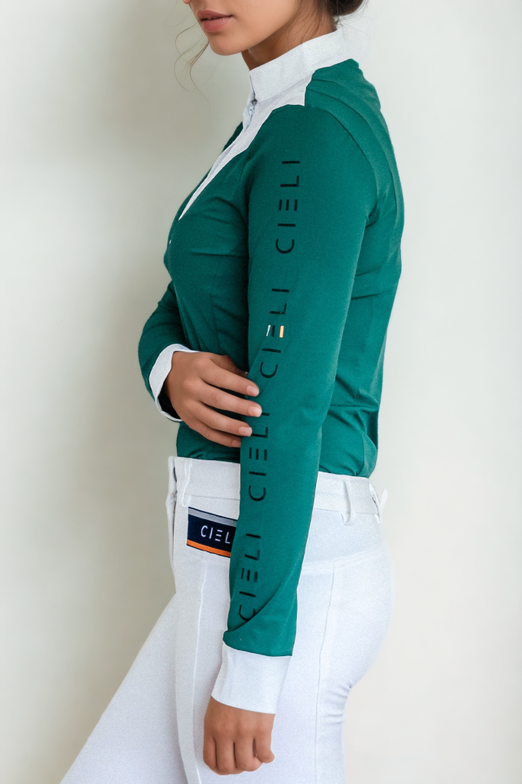 Ladies Cieli Equestrian riding long sleeve show shirt in green with white bib and magnetic closure.