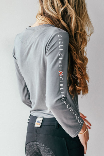 Lady wearing a Cieli Equestrian long sleeve horse riding shirt in grey with ultra soft fabric.