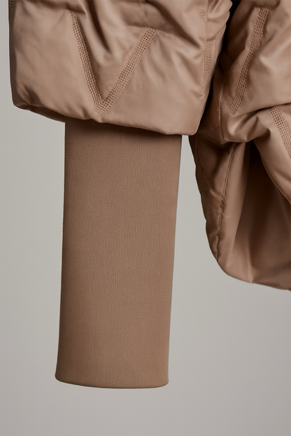 Close-up of a brown jacket and sleeve on a neutral background
