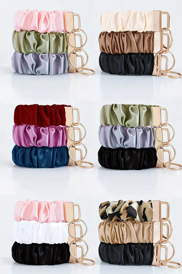 Set of colorful scrunchies in various patterns and colors on a white background