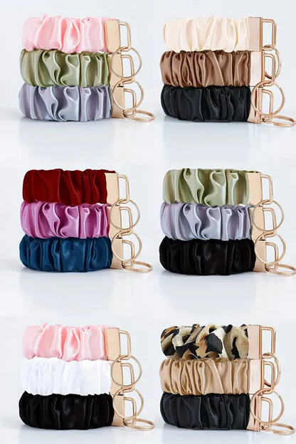 Set of colorful scrunchies in various patterns and colors on a white background