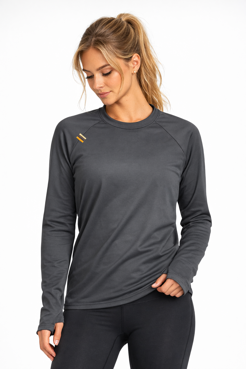 Woman wearing a gray long-sleeve athletic shirt on a white background