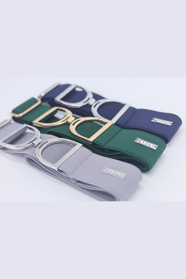 Three belts in green, gold, and blue with visible brand logos on a light gray background