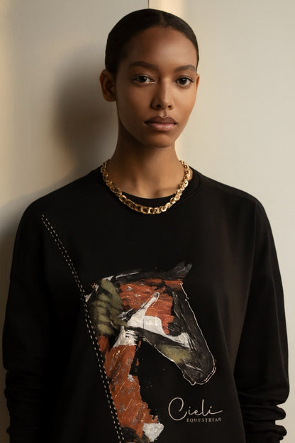 Model wearing a black sweatshirt with a horse graphic and 'Cieli' branding.